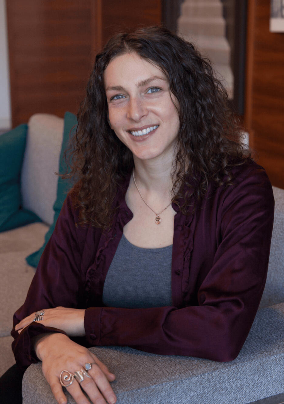 Smiling woman with curly brown hair